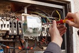 Repair of old electrical switchgear. An electrician replaces old electrical wiring devices, Output Electrical Group, Bundoora