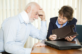 Injured senior man and his accountant worrying about the cost of medical bills., Injury Lawyer Firm, Downey